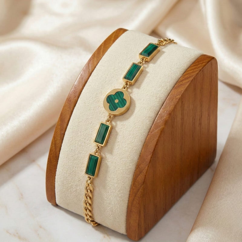 An elegant gold bracelet made of rust-resistant stainless steel, featuring a small, distinctive green flower at its center, adorned with green stones. It has an adjustable clasp for a perfect fit. - Image 5